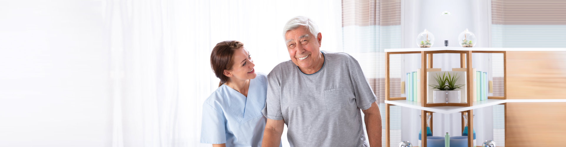 staff and elderly man smiling