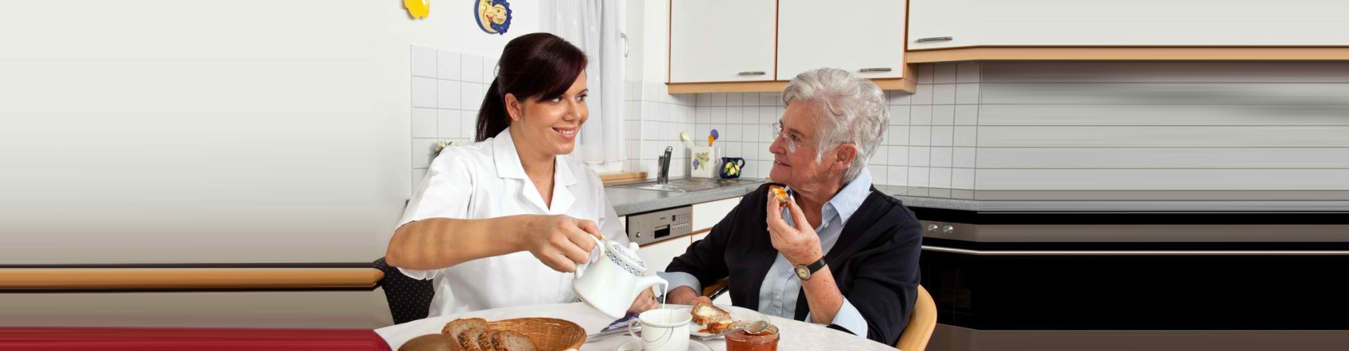 young lady assisting the senior woman on her meal