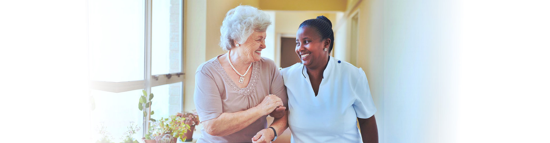 staff and elderly woman smiling