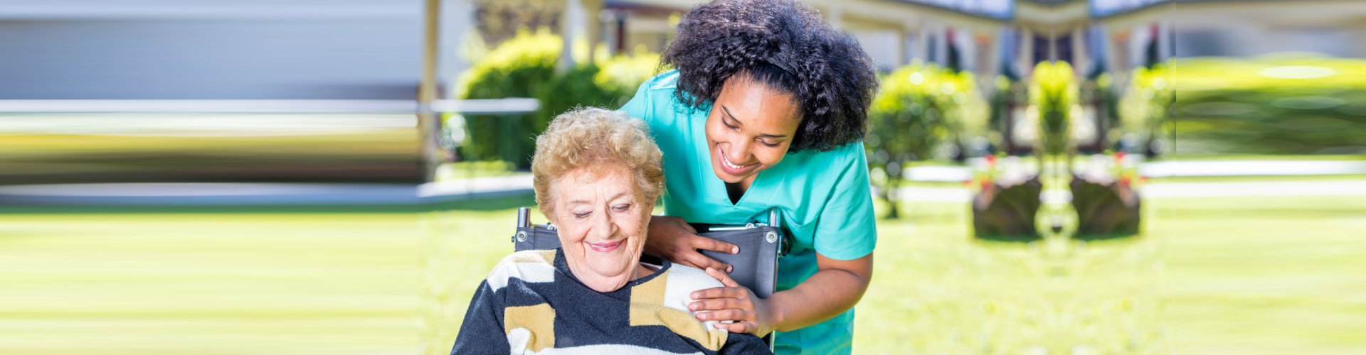 staff and elderly woman smiling